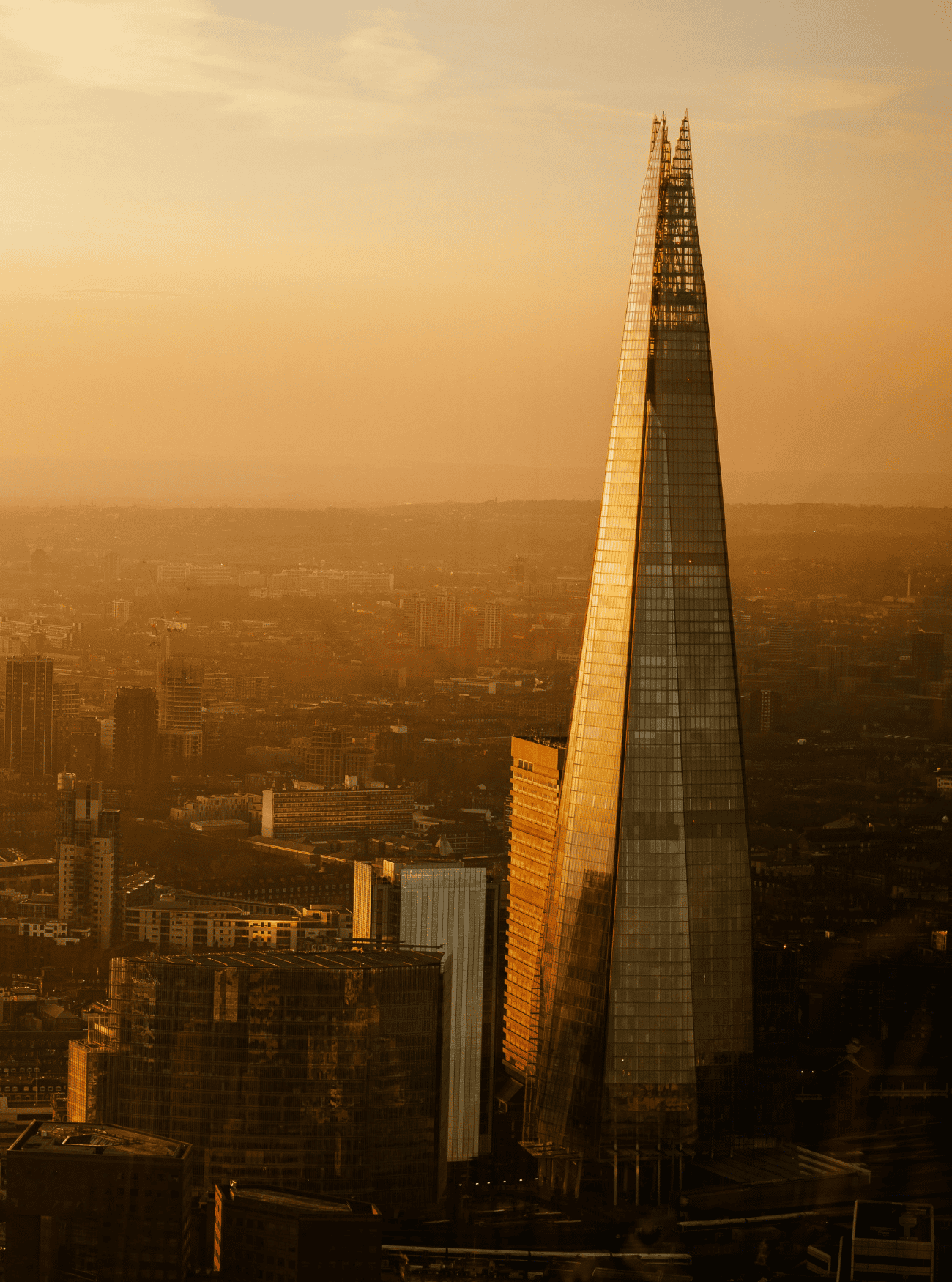 Golden Shard skyscraper at sunset in London.
