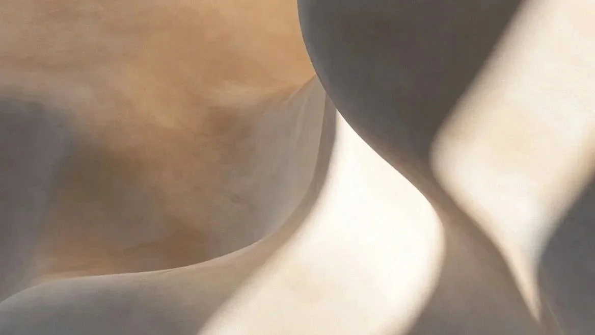 Close-up of folded metallic or fabric material with smooth and shiny surfaces.