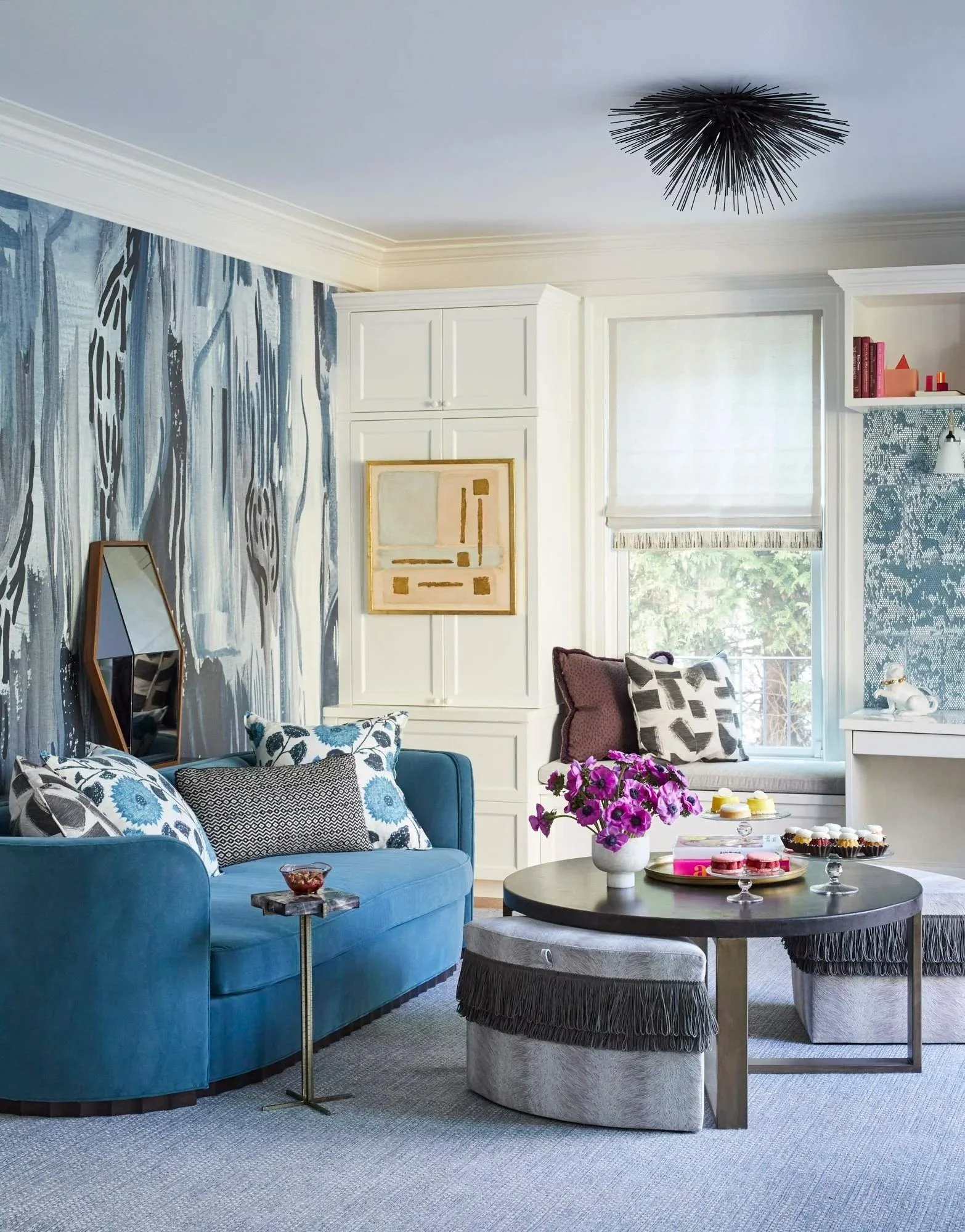 Blue-and-white sitting room with patterned walls, layered seating, and sculptural lighting from the Suburban Chic portfolio.