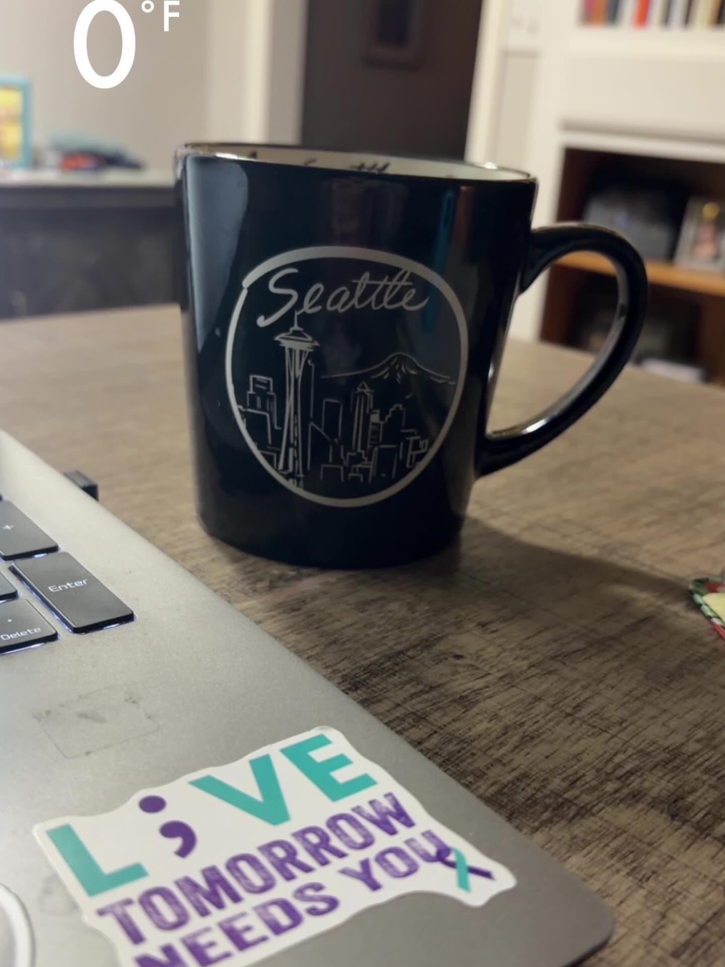 0&deg; this morning&hellip;..feels a little rude honestly 🥶

Seattle mug doing the heavy lifting. ☕
Laptop&rsquo;s open&hellip; brain&rsquo;s getting there. 💻

Also&hellip; peep the sticker reminder:
L;VE tomorrow needs you. 💜

Happy Monday, frien
