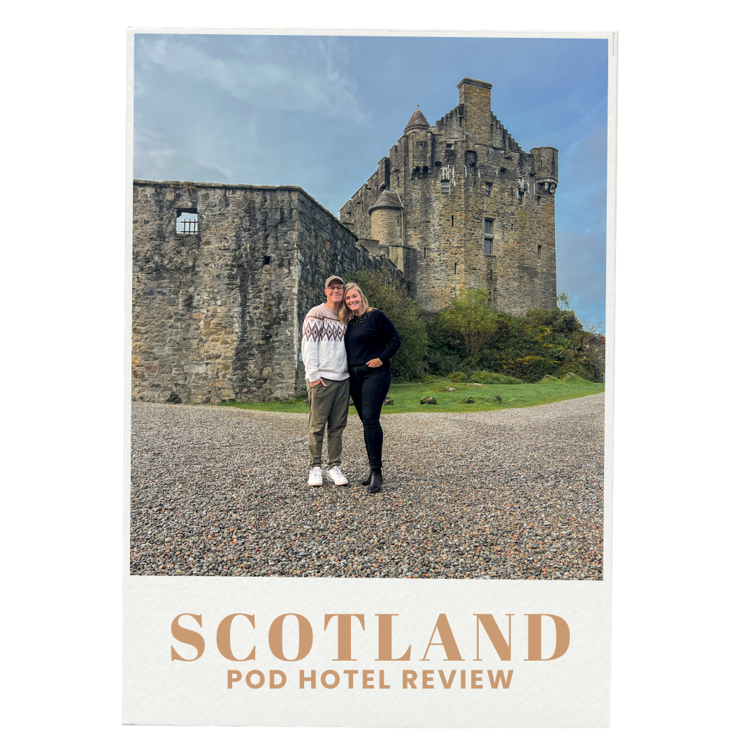 A photograph of two people standing in front of a medieval castle at Pod Hotel Scotland, with the text 'SCOTLAND POD HOTEL REVIEW' at the bottom.