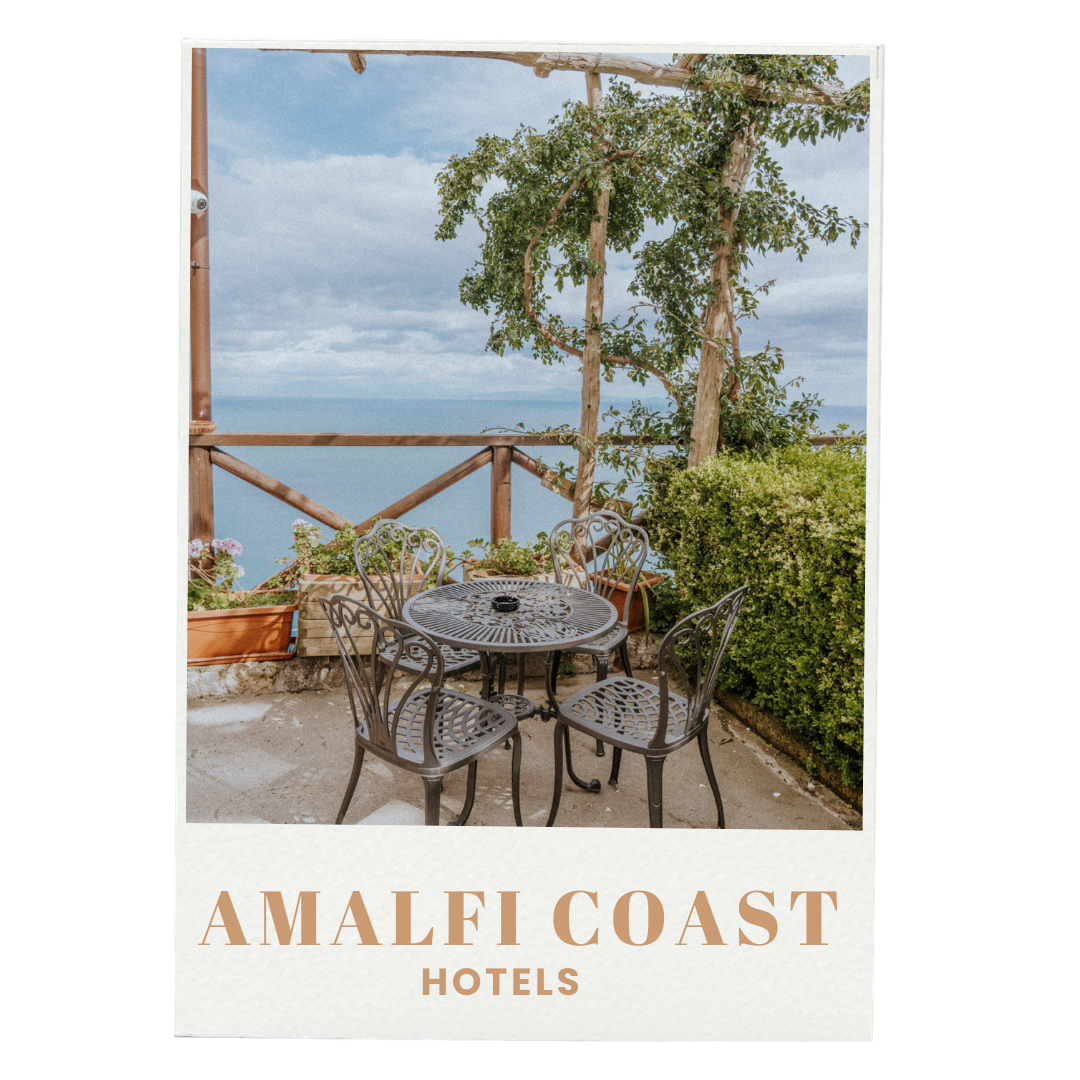 Outdoor terrace with black metal table and four matching chairs, surrounded by potted plants and greenery, overlooking the sea on a partly cloudy day, advertising Amalfi Coast hotels.