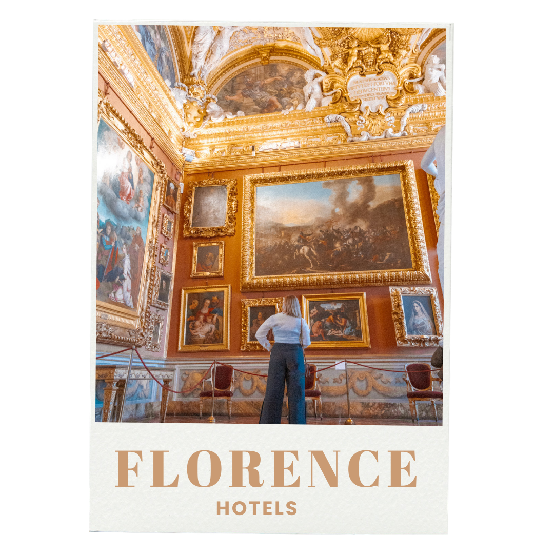 An individual observing artworks in an opulent, gold-accented art gallery with baroque-style paintings, ornate ceiling decorations, and classical sculptures.