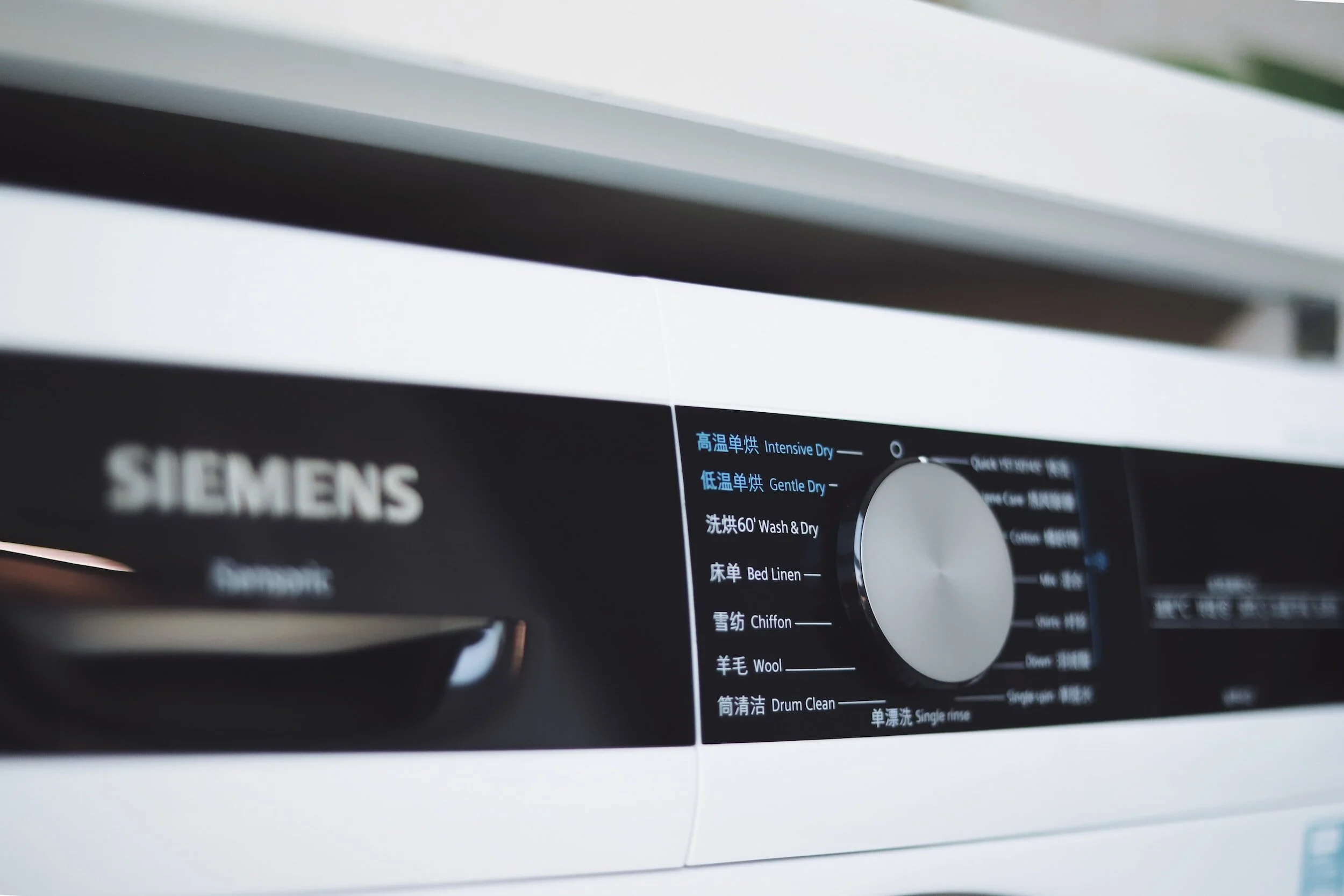 Close-up of a Siemens washing machine control panel with various wash and dry settings.