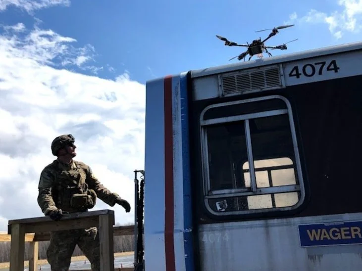 Explosive ordnance disposal technician examining weaponized drone during training exercise