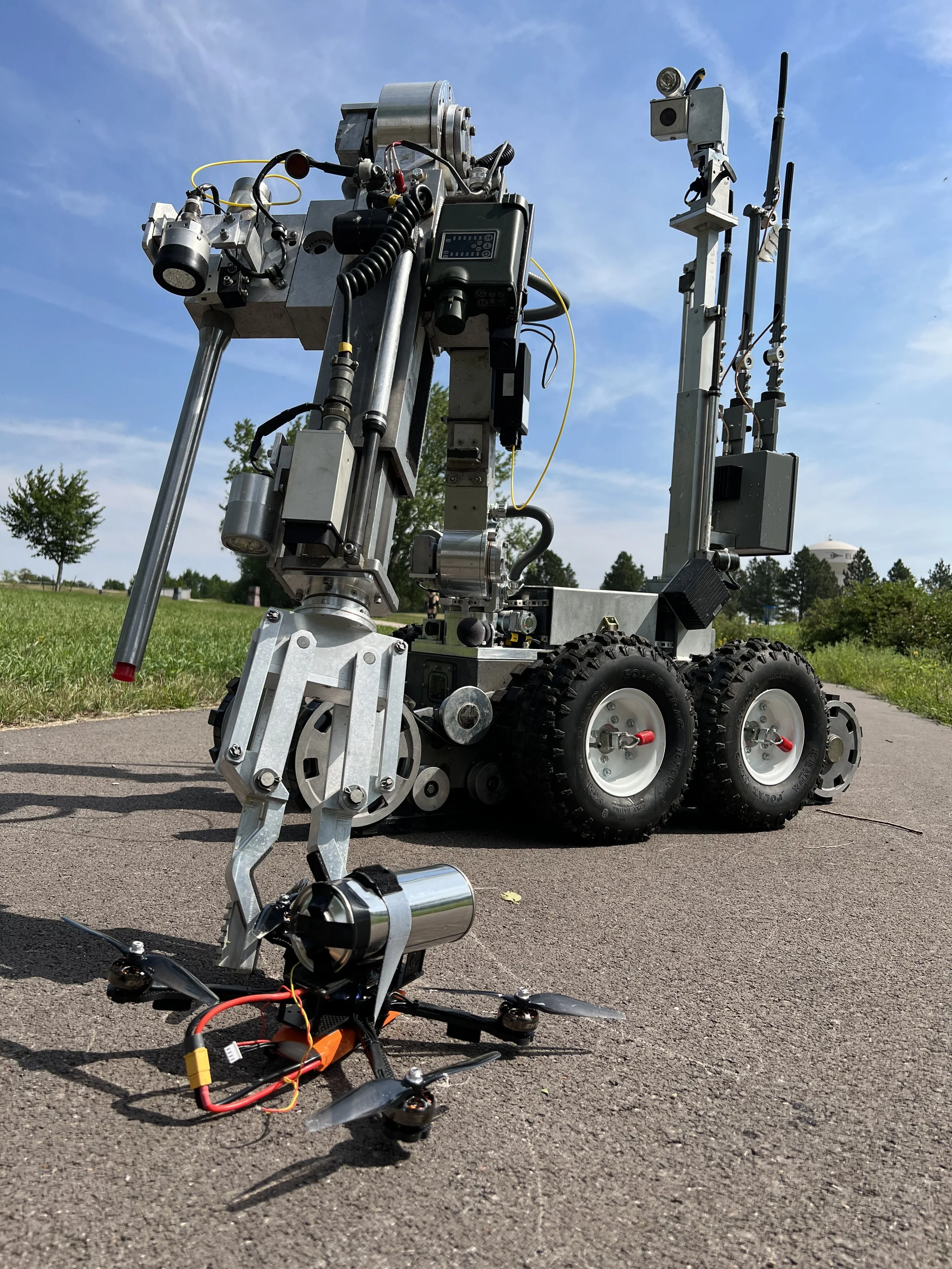 Scene representing explosive ordnance disposal personnel conducting weaponized drone response training.