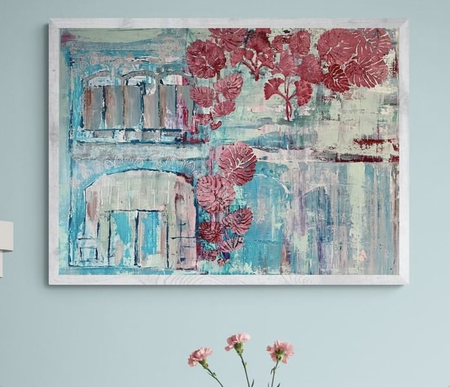Abstract painting featuring a bridge, red flowers, and a river scene in pastel colors on a light blue wall, with pink flowers in the foreground
