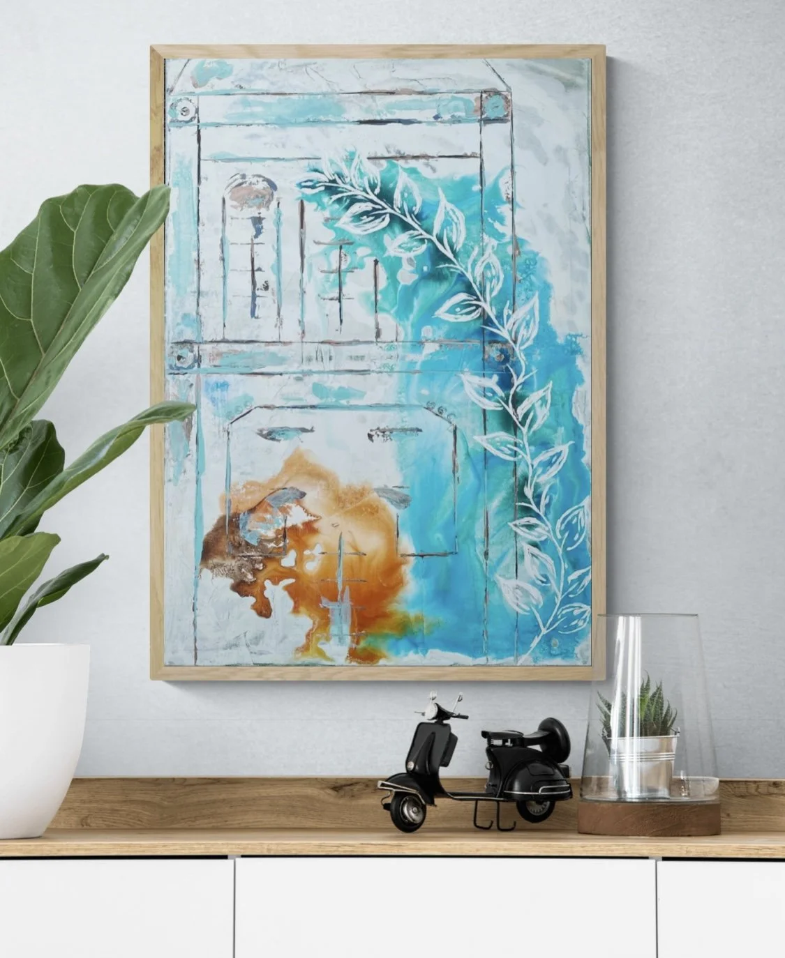 Abstract painting with a frame, featuring blue, orange, and white colors, depicting a leaf pattern and distressed wooden texture. Besides the painting, there is a green plant in a white pot, a small black scooter decor, and a glass container with a p