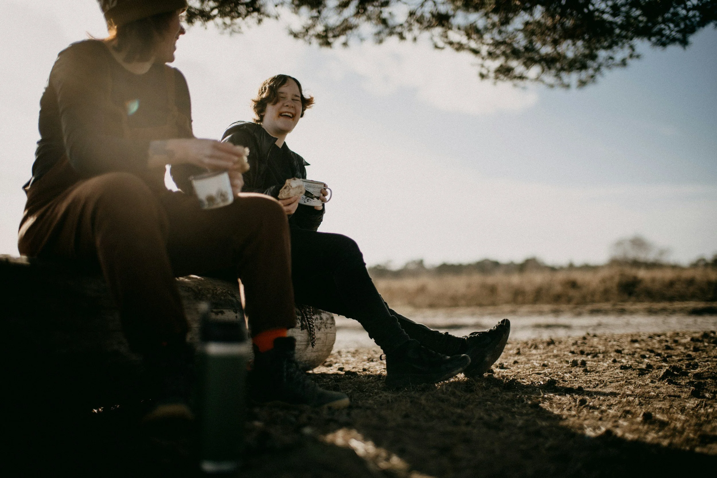 two teens sitting outside