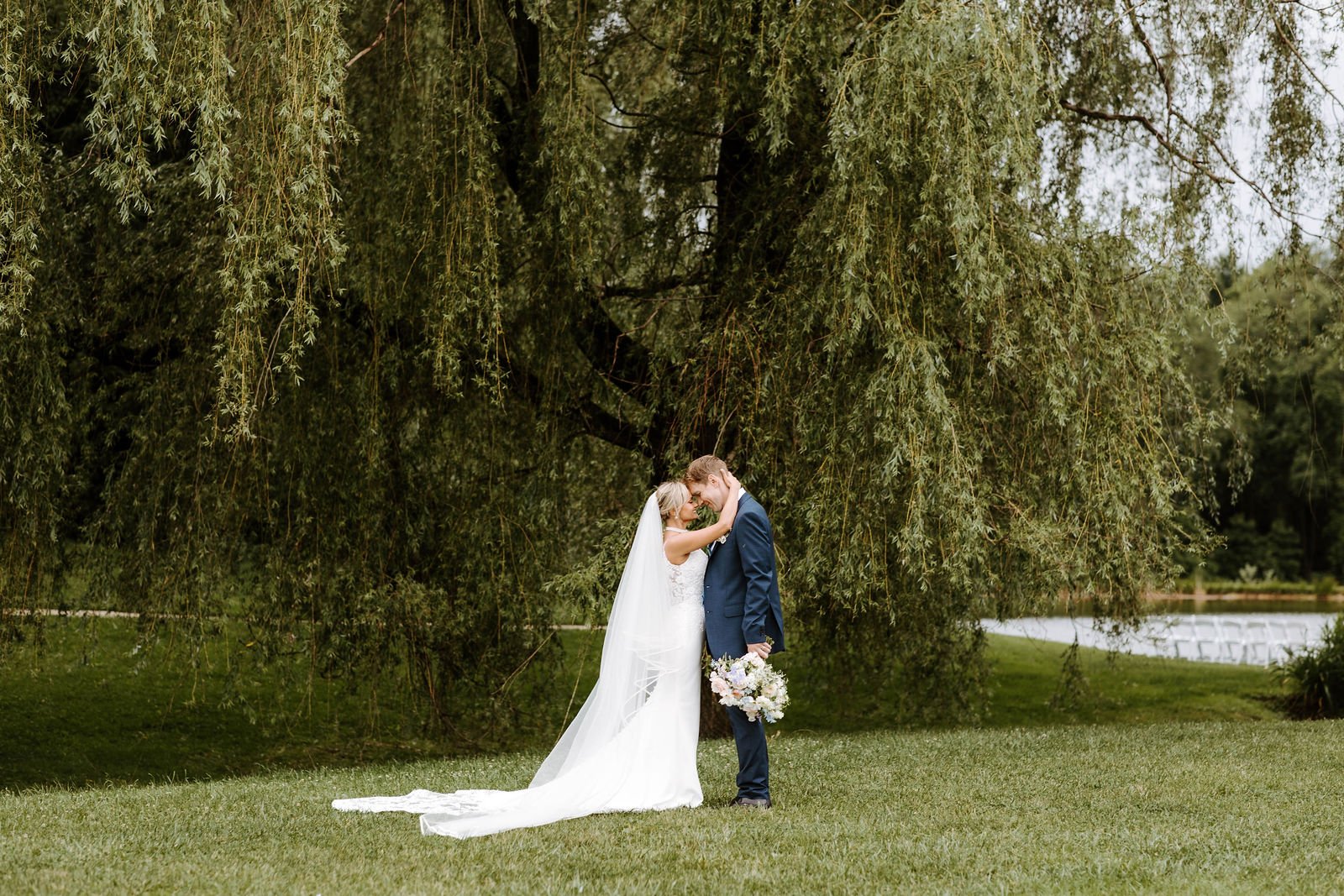 Brett and his wife Jenny kiss beneath a willow tree on their wedding day