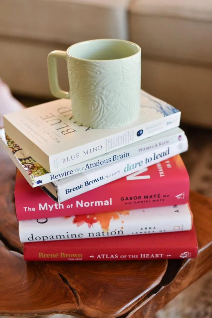 a coffee mug on top of a stack of books