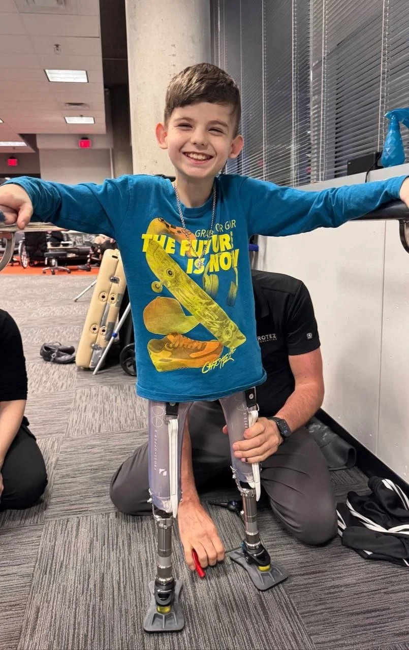 Volodya standing on his new training prosthetics