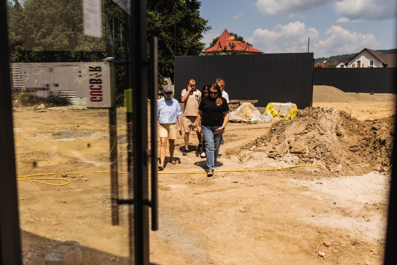 Adults walking across a cleared construction site