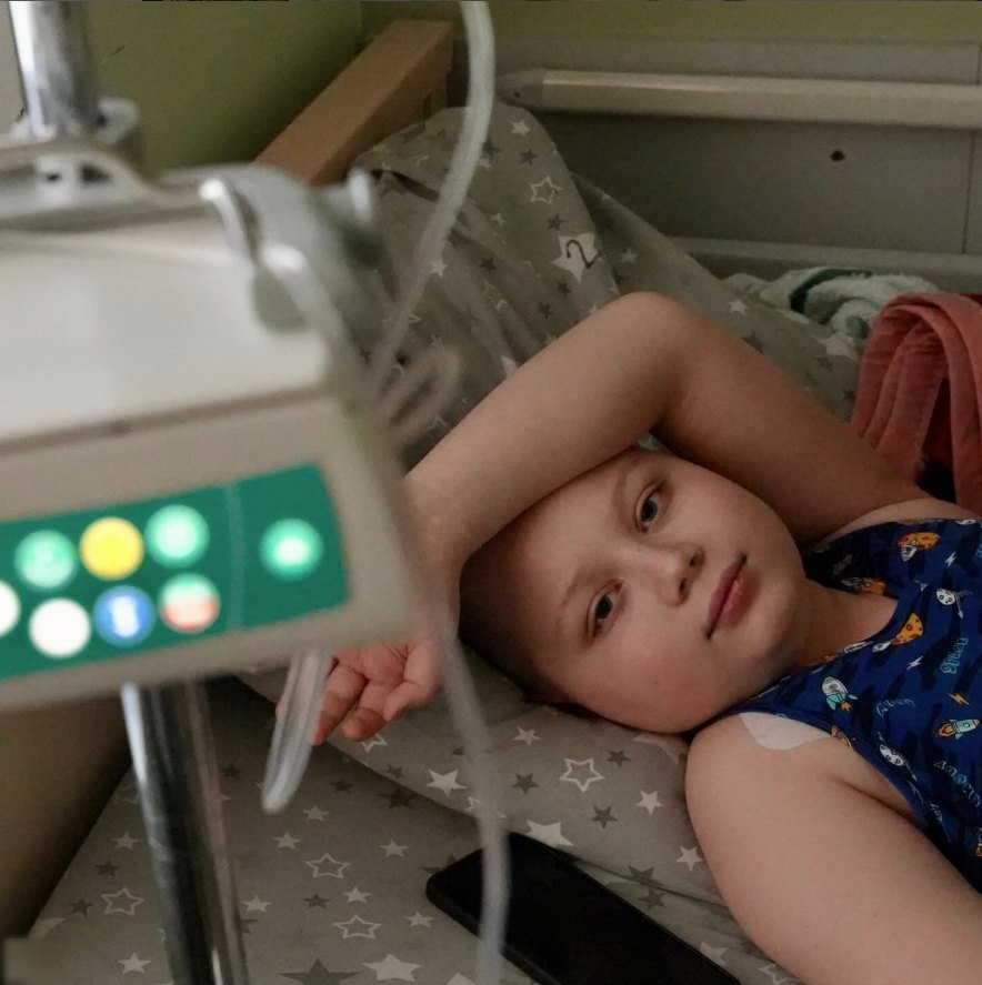 A child resting in a hospital bed