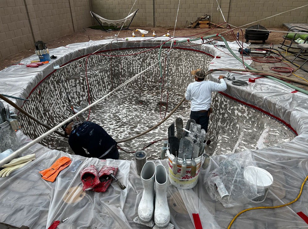 Old, cracked swimming pool in Phoenix, AZ, before resurfacing and restoration by Foothills Pools.