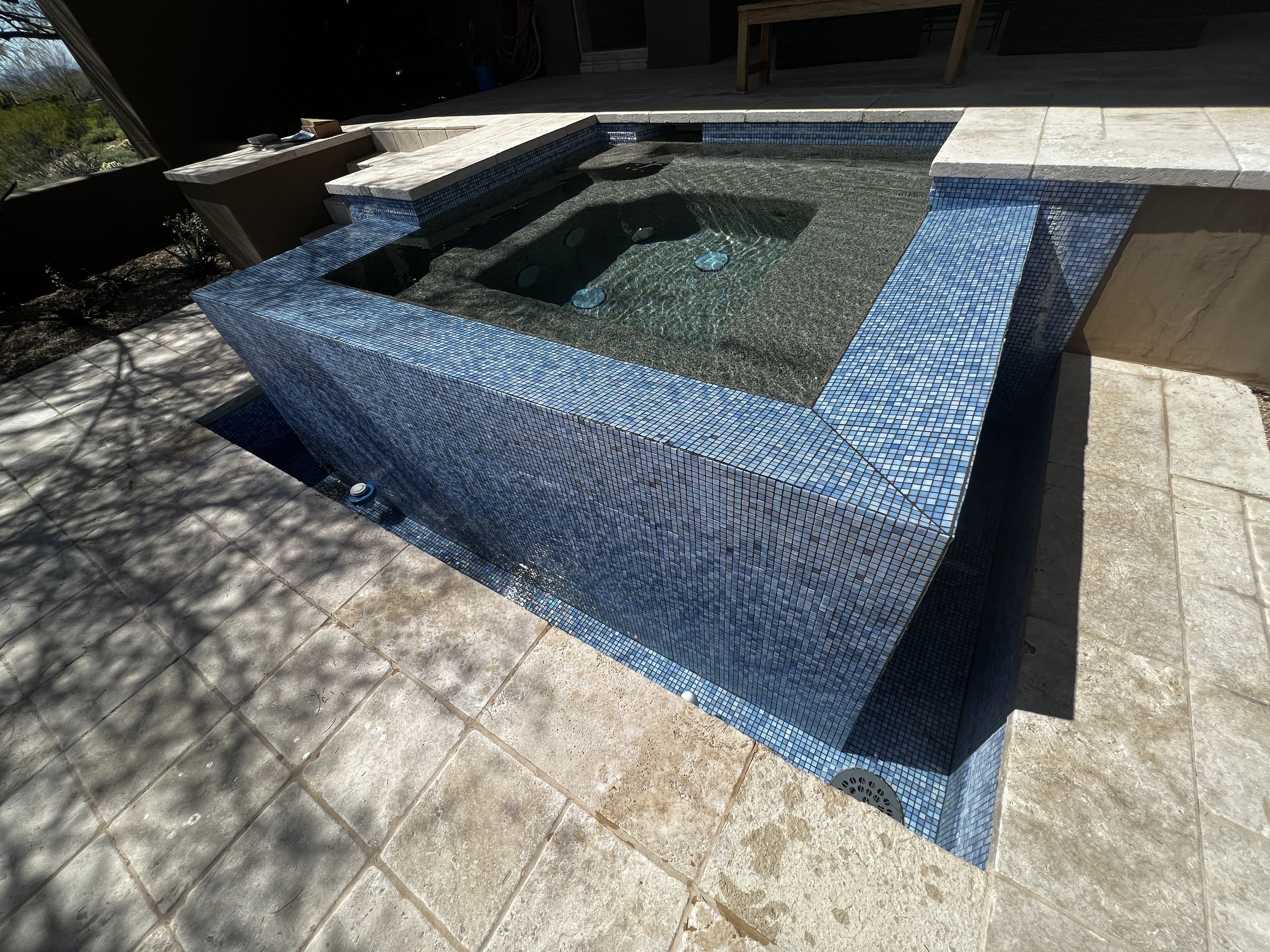 Old, $1" \times 1"$ tiled spa structure with negative edge spillover basin before renovation by Foothills Pools.
