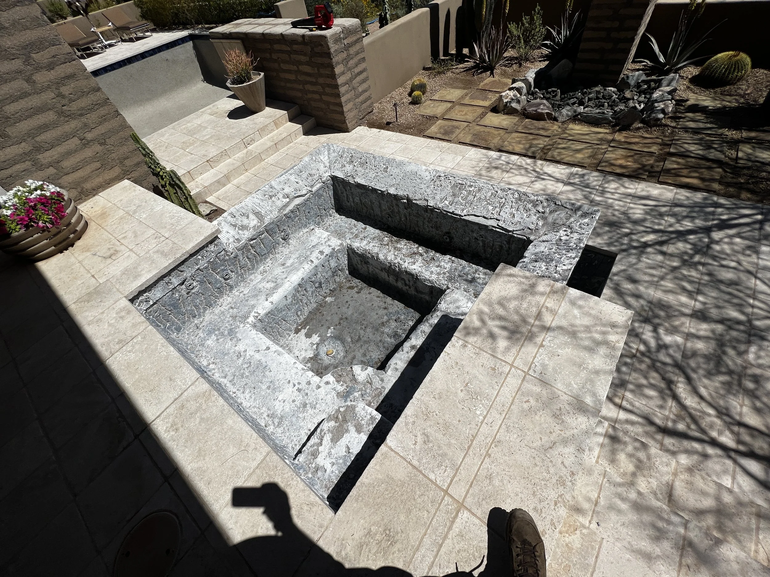 Bare spa structure and negative edge basin after old tile removal, prepped for remodeling in Phoenix, AZ.