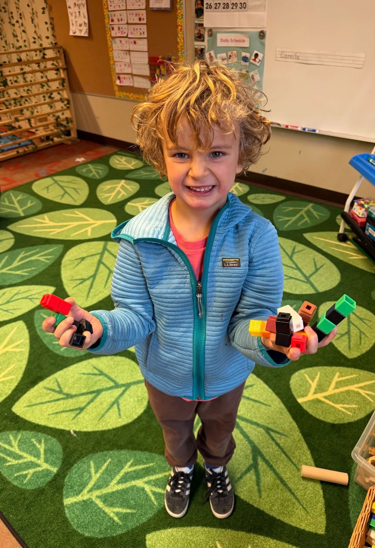 Child smiling and holding blocks
