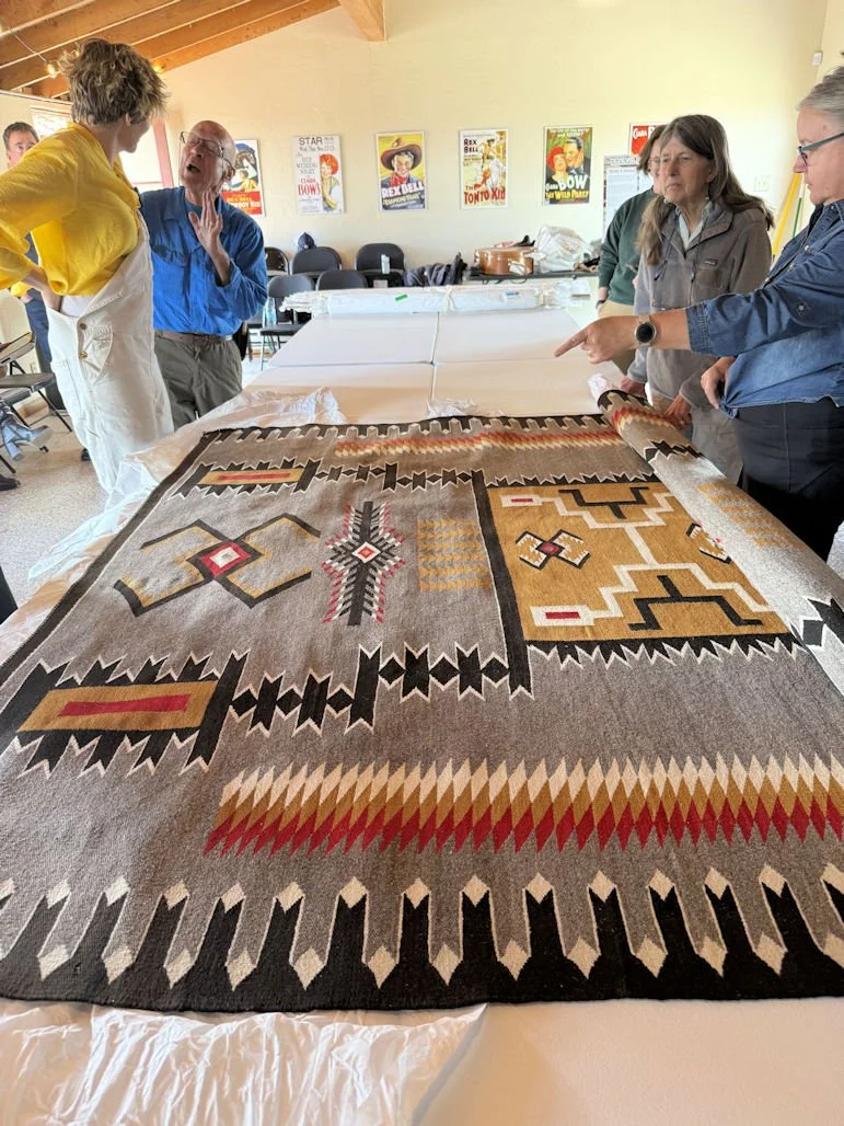 Navaho Rug presentation - Rolling out the rugs.jpg