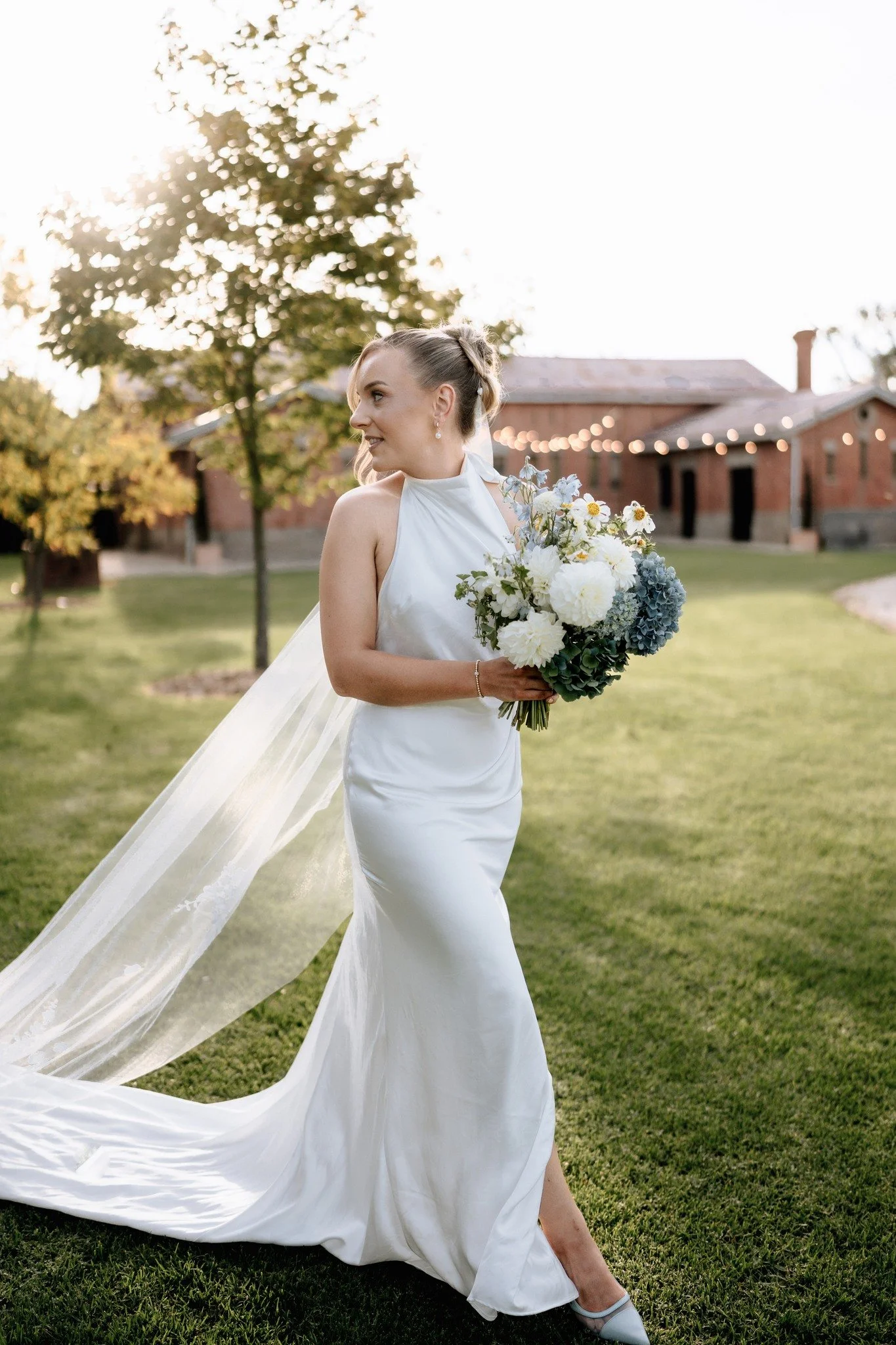 Ohhh, how gorgeous did Emily look? ✨ @emmjobson

A low back that feels effortless, a veil that moves softly with the day, and a subtle slit designed for ease and elegance.

Finished with baby blue shoes a thoughtful touch, perfectly echoing her flora