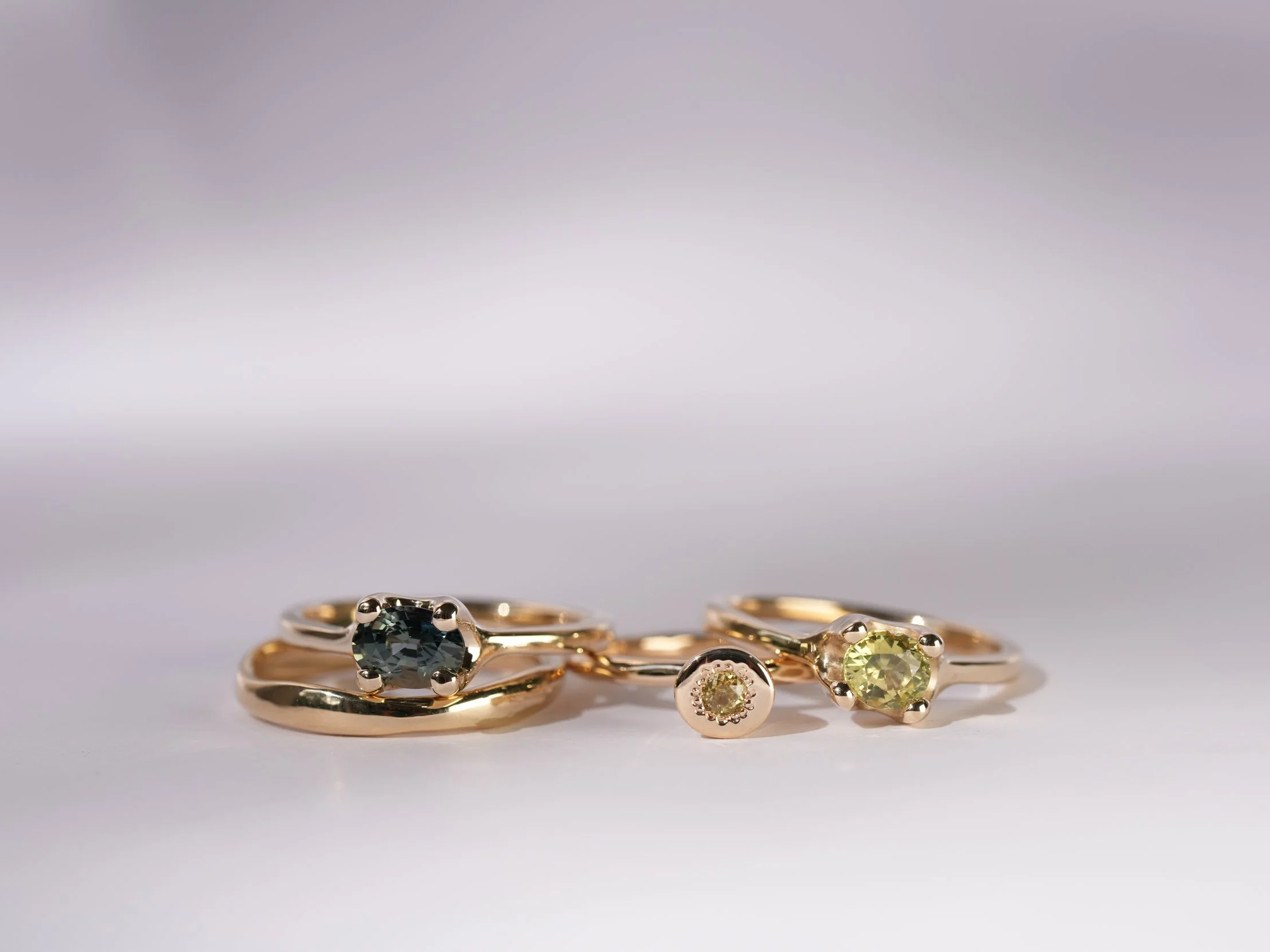 Green and blue sapphires set in the Petite Claw and Cone rings ~ 9ct yellow gold