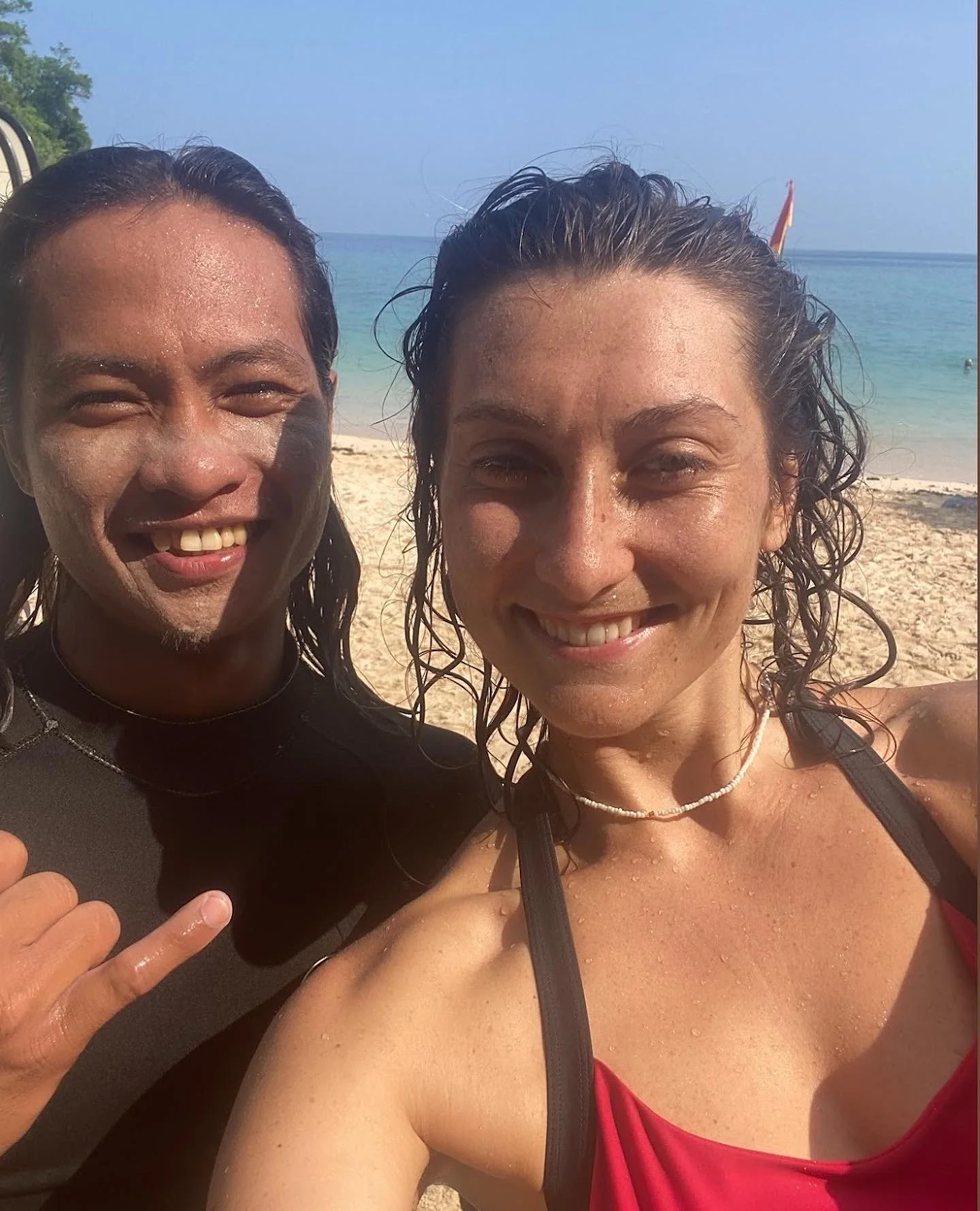 Peak Surf Bali Students at Padang Padang Beach Uluwatu Surfing Peak Surf Bali Surf School high five smiles fun happy joy friendship surfing beautiful beach crystal clear water white sand teaching surf surfer girl