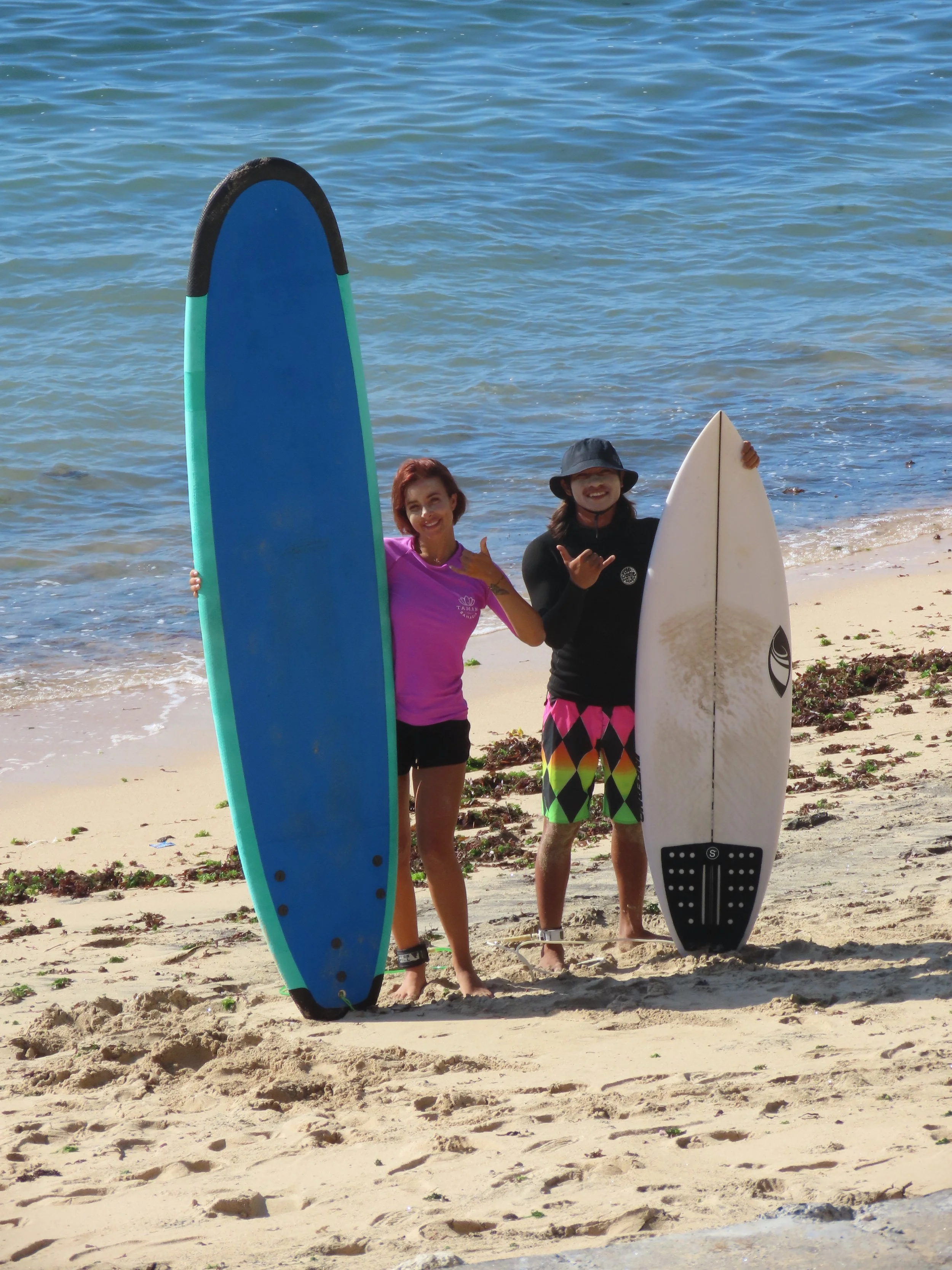 Rym Renom France French Peak Surf Bali Students at Padang Padang Beach Uluwatu Surfing Peak Surf Bali Surf School high five smiles fun happy joy friendship surfing beautiful beach crystal clear water white sand celebrity pink teaching surf surfer gir