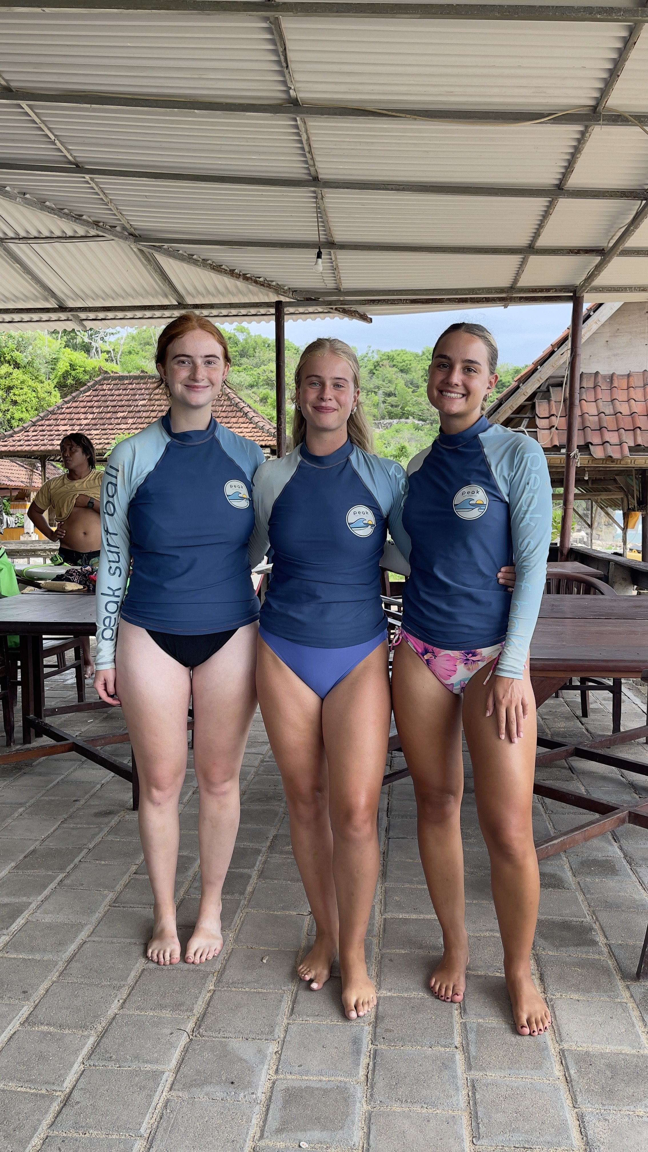 Peak Surf Bali Students at Nusa Dua Beach Uluwatu Surfing Peak Surf Bali Surf School high five smiles fun happy joy friendship surfing beautiful beach crystal clear water white sand teaching surf surfer girl