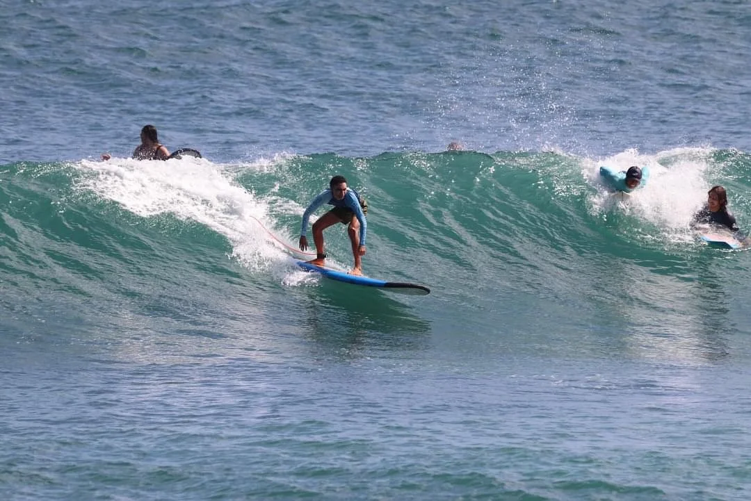 British UK United Kingdom England English Peak Surf Bali Students at Padang Padang Beach Uluwatu Surfing Peak Surf Bali Surf School high five smiles fun happy joy friendship surfing beautiful beach crystal clear water white sand teaching surf surfer 