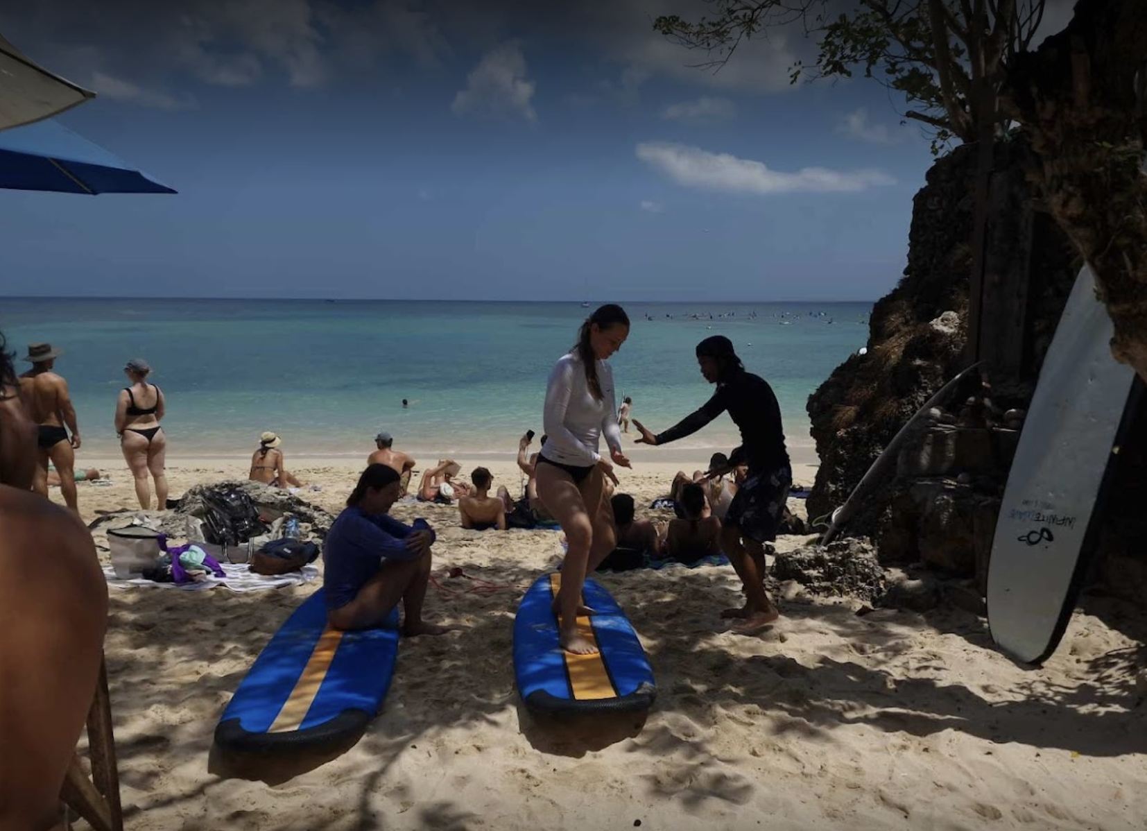 Peak Surf Bali Students at Padang Padang Beach Uluwatu Surfing Peak Surf Bali Surf School high five smiles fun happy joy friendship surfing beautiful beach crystal clear water white sand teaching surf surfer girl