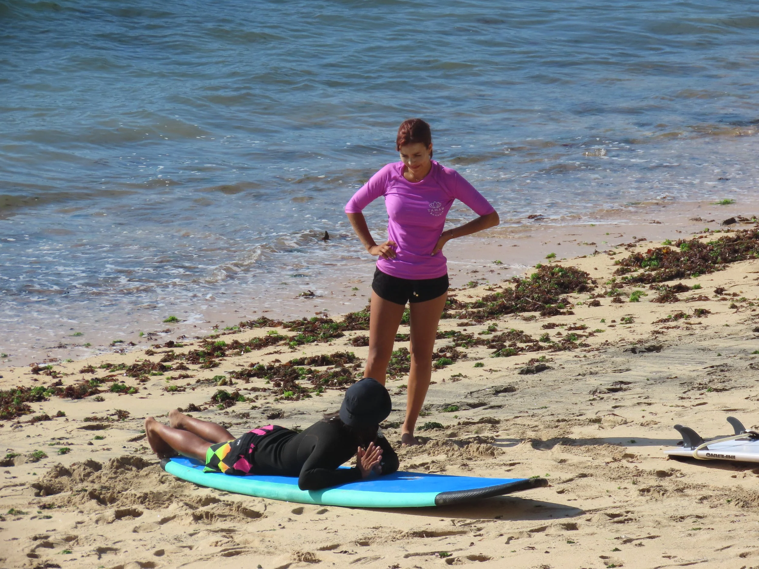 Rym Renom France French Peak Surf Bali Students at Padang Padang Beach Uluwatu Surfing Peak Surf Bali Surf School high five smiles fun happy joy friendship surfing beautiful beach crystal clear water white sand celebrity pink teaching surf surfer gir