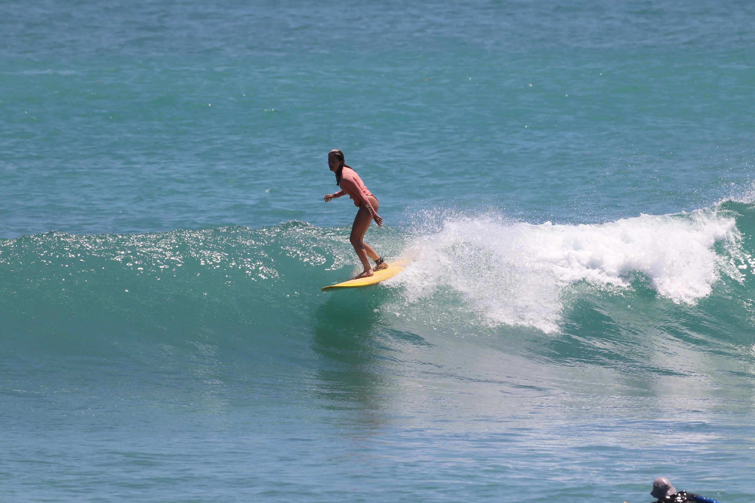 Peak Surf Bali Students at Padang Padang Beach Uluwatu Surfing Peak Surf Bali Surf School high five smiles fun happy joy friendship surfing beautiful beach crystal clear water white sand teaching surf surfer girl