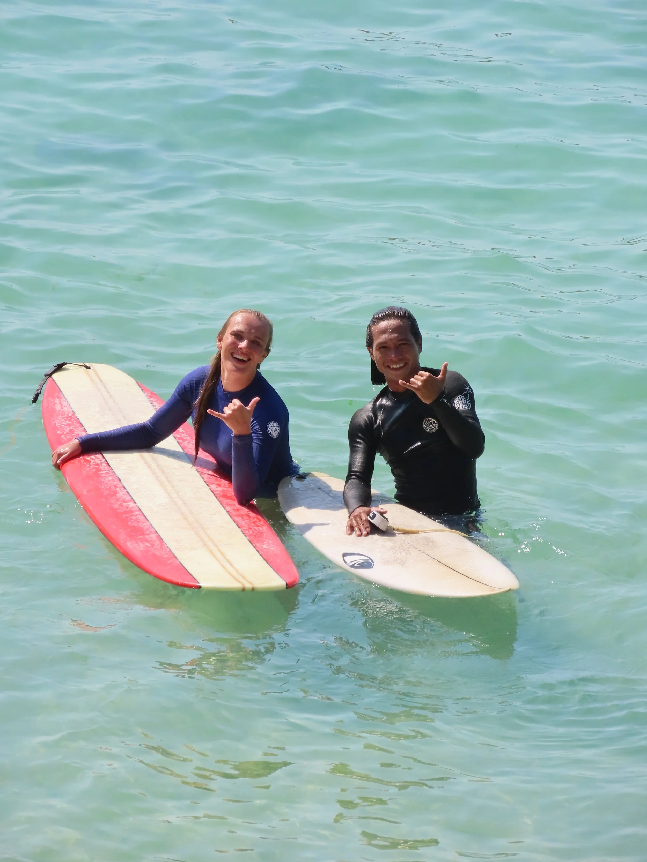 Danique Peak Surf Bali Students at Padang Padang Beach Uluwatu Surfing Peak Surf Bali Surf School high five smiles fun happy joy friendship surfing beautiful beach crystal clear water white sand teaching surf surfer girl