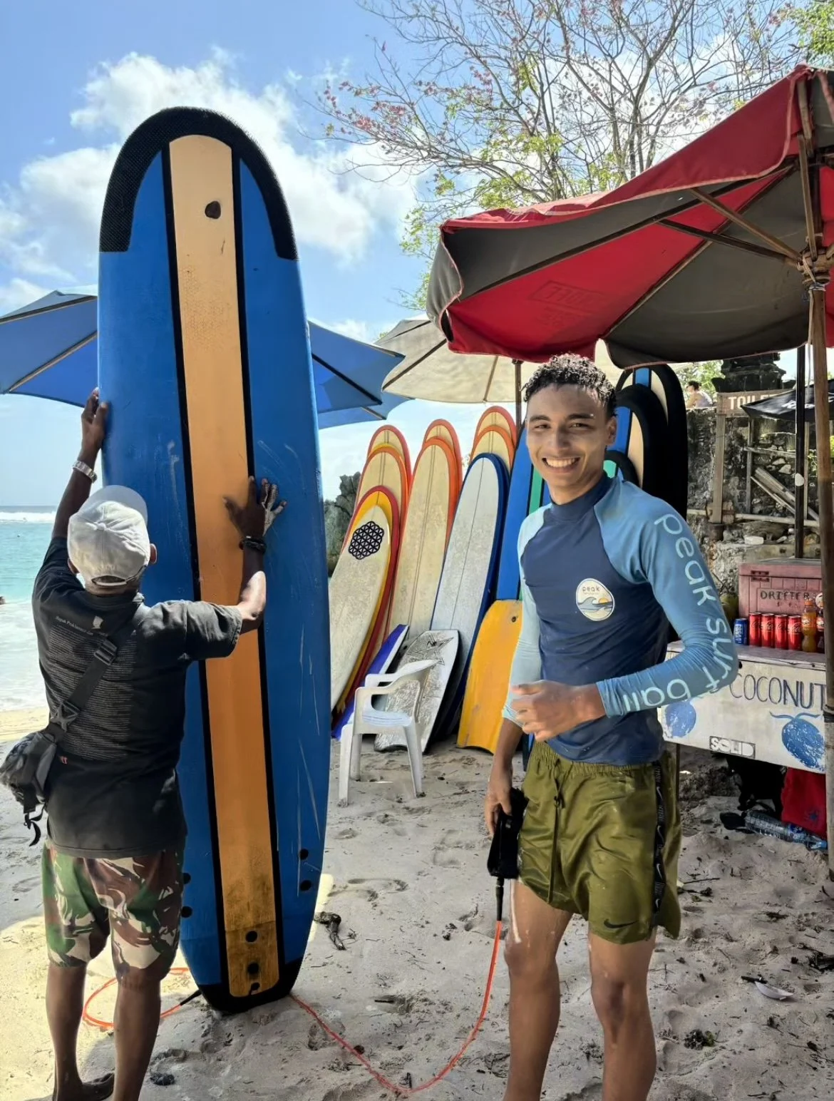 Peak Surf Bali Students at Padang Padang Beach Uluwatu Surfing Peak Surf Bali Surf School high five smiles fun happy joy friendship surfing beautiful beach crystal clear water white sand teaching surf surfer surfboard