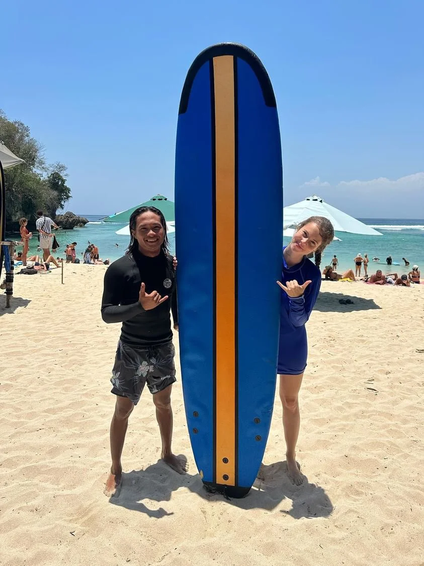 Peak Surf Bali Students at Padang Padang Beach Uluwatu Surfing Peak Surf Bali Surf School high five smiles fun happy joy friendship surfing beautiful beach crystal clear water white sand teaching surf surfer girl surfboard