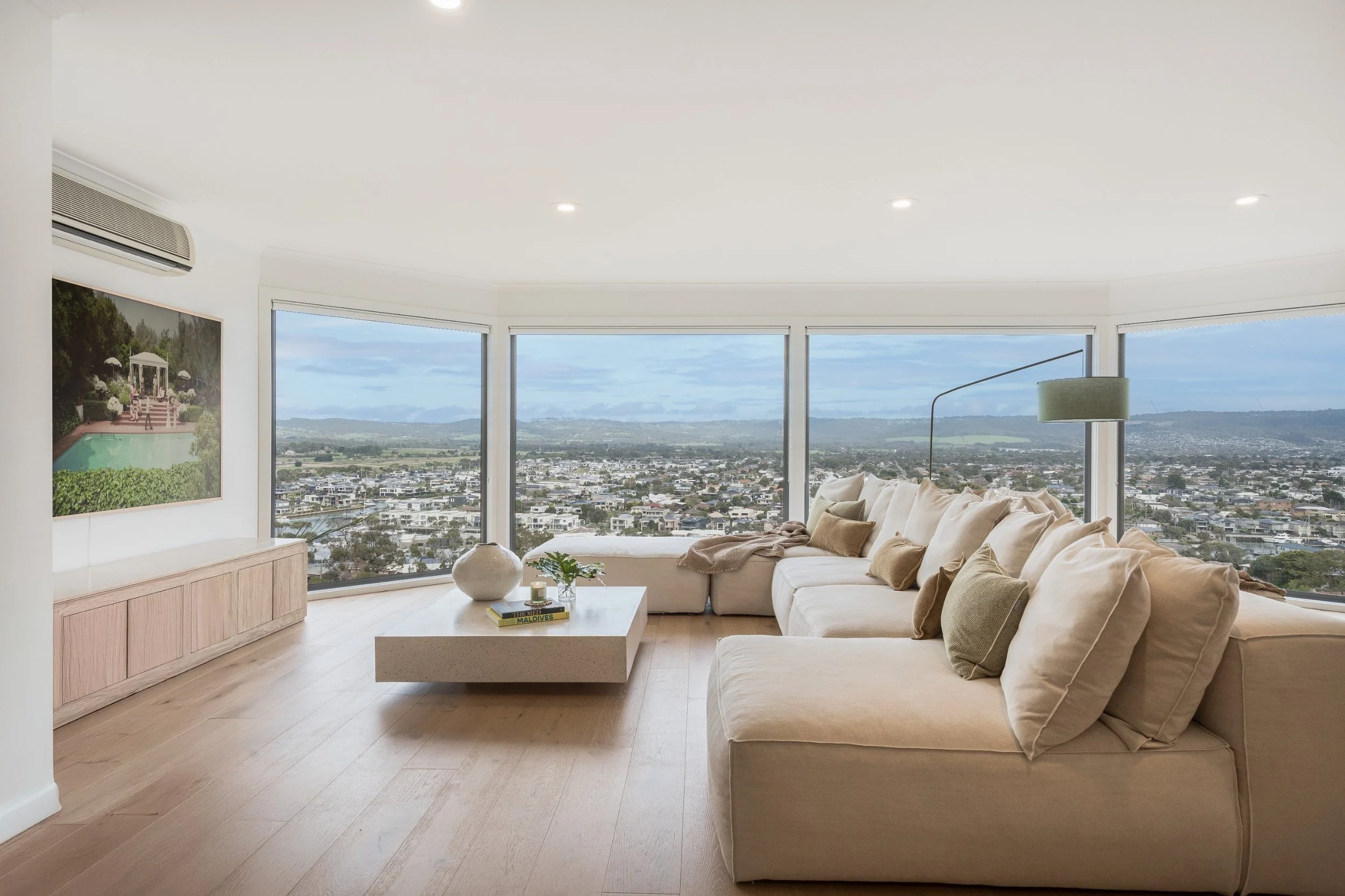 Holiday home living room with a large cream sofa and panoramic views
