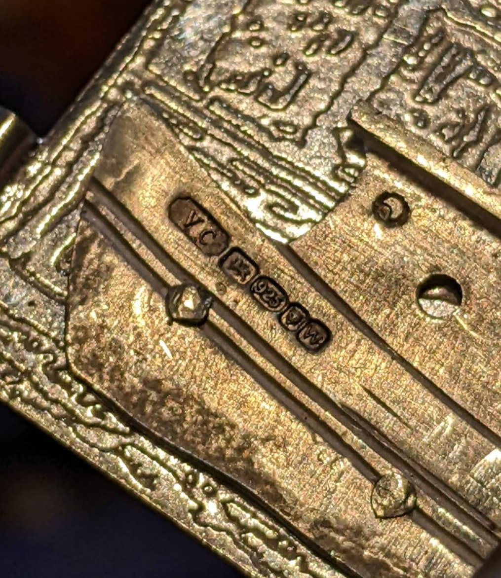 Close-up of the boat with engraved hallmarks and textured design.