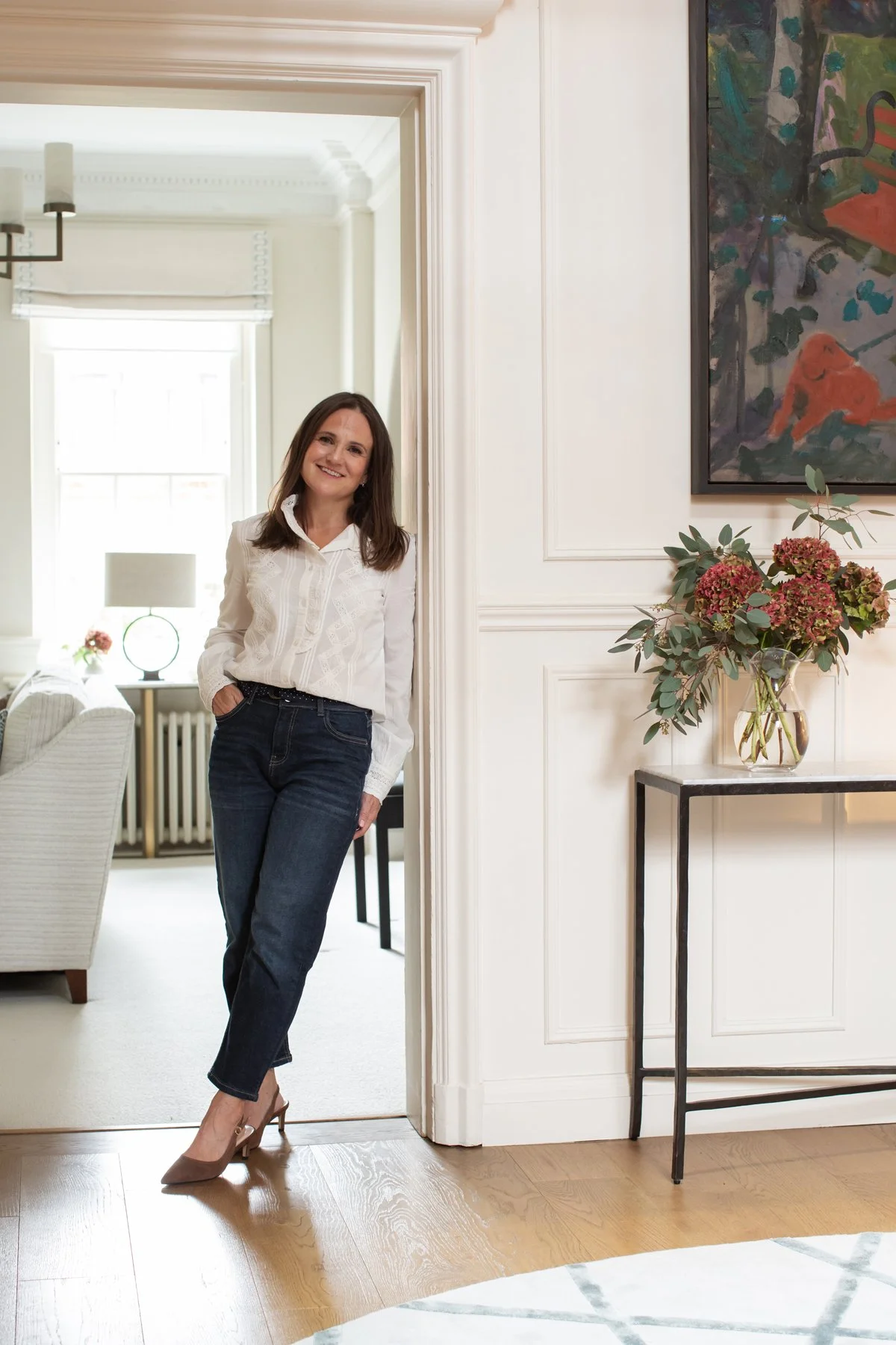 female-business-woman-leaning-wall-smiling-looking-at-camera