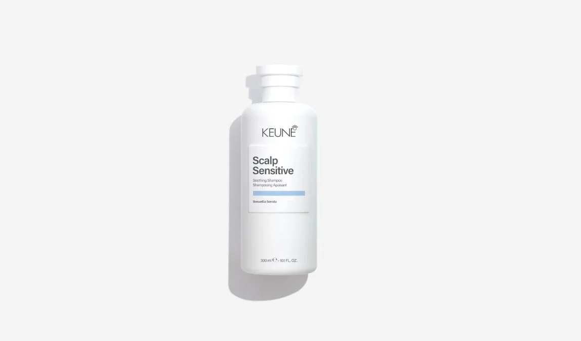 A white bottle of KEUNE Scalp Sensitive soothing shampoo, with a label indicating it is for sensitive scalps and contains Boswellia Serrata, standing upright on a white background.