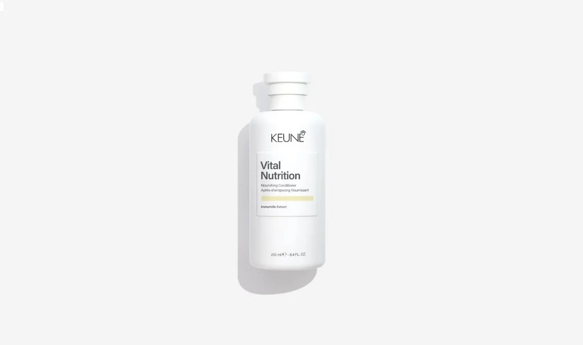 White bottle of Keune Vital Nutrition nourishing conditioner with a white cap on a white background.