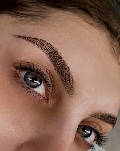 Close-up of a woman's face showing her eyes, eyebrows, and part of her forehead.