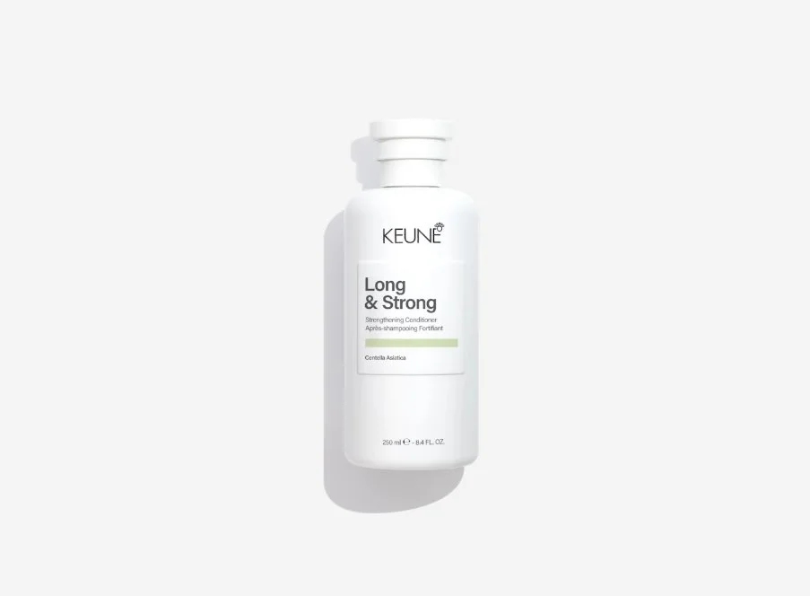 A white bottle of KEUNE Long & Strong strengthening conditioner with a white cap, placed on a light gray background.