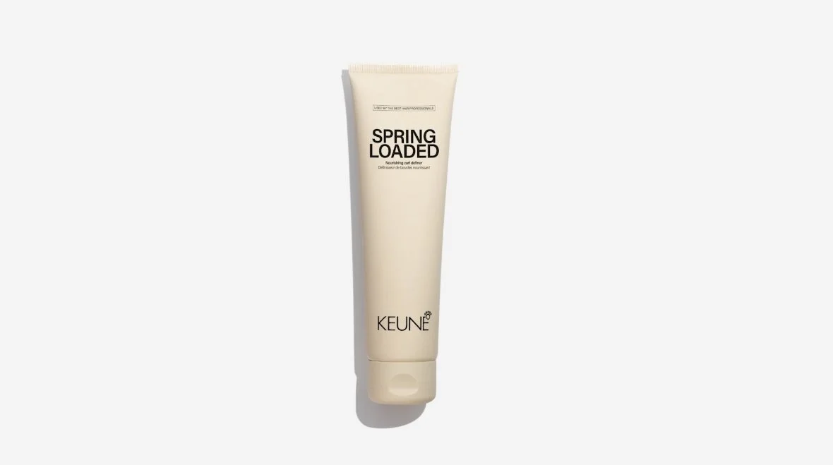 A beige tube of Keune Spring Loaded nourishing curl definer hair product displayed vertically against a light background.