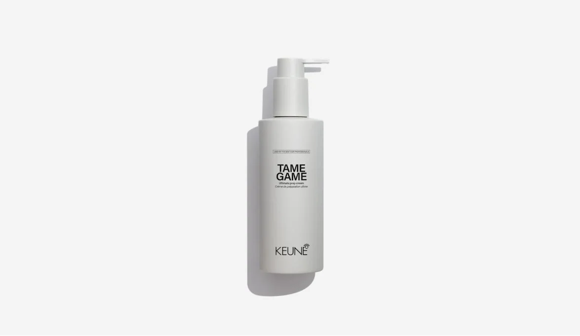 A white bottle of KEUNE TAME GAME ultimate prep cream with a pump dispenser on a plain white background.