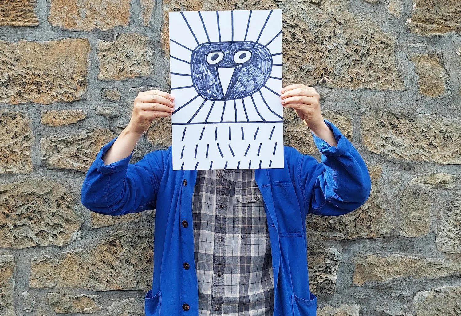 Portrait of Marcus Oakley, 2023, holding a drawing representing a bird