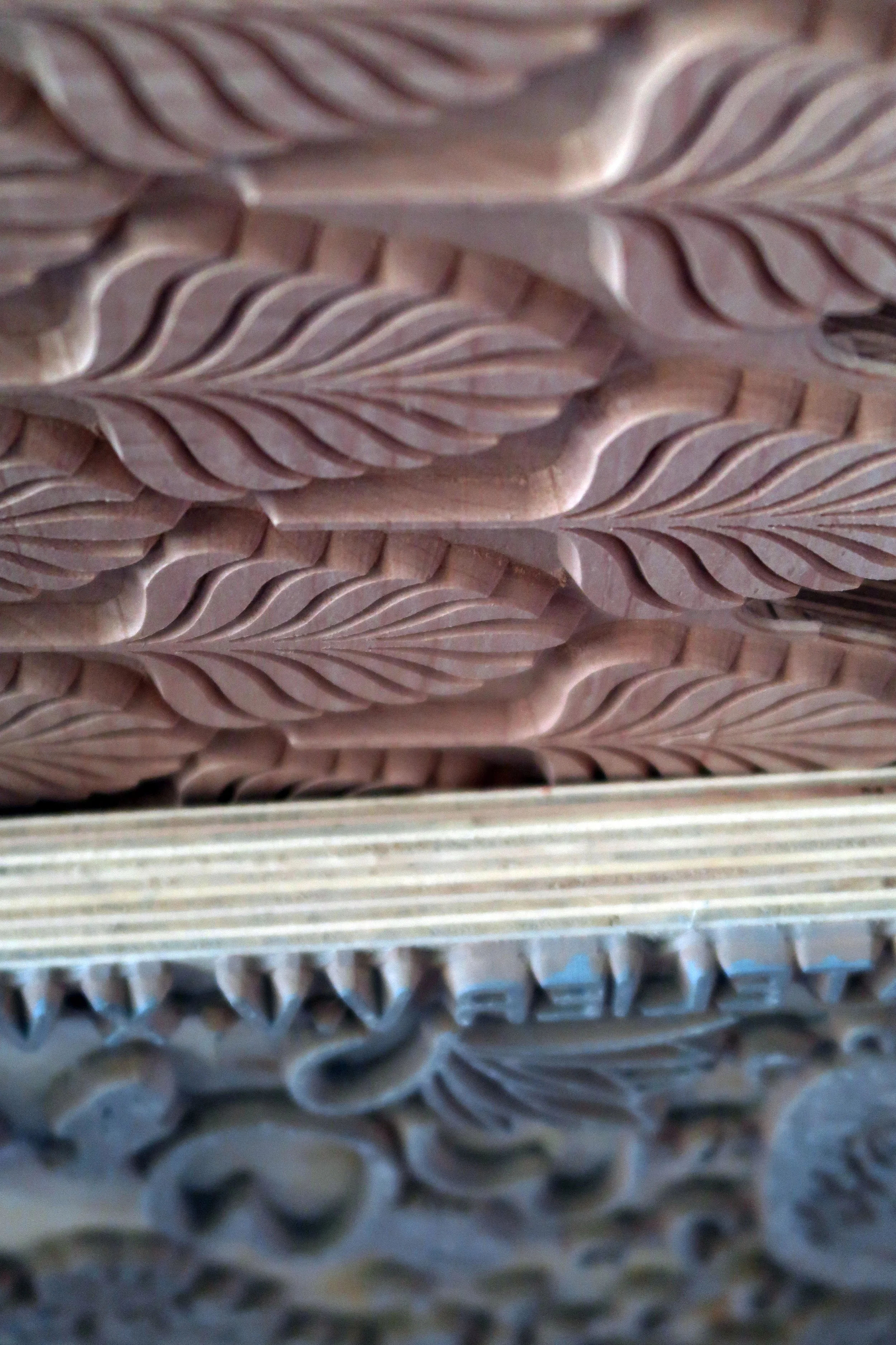 Close-up of multiple stacks of wooden stamps to print wallpaper, arranged in a neat and layered pattern.