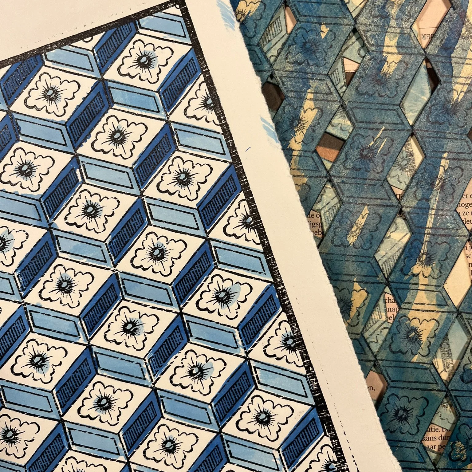 Close-up of a detailed, geometric blue and white pattern design on paper, with a portion of a similar pattern layered underneath and some visible text in the background. A dominoté with stencils