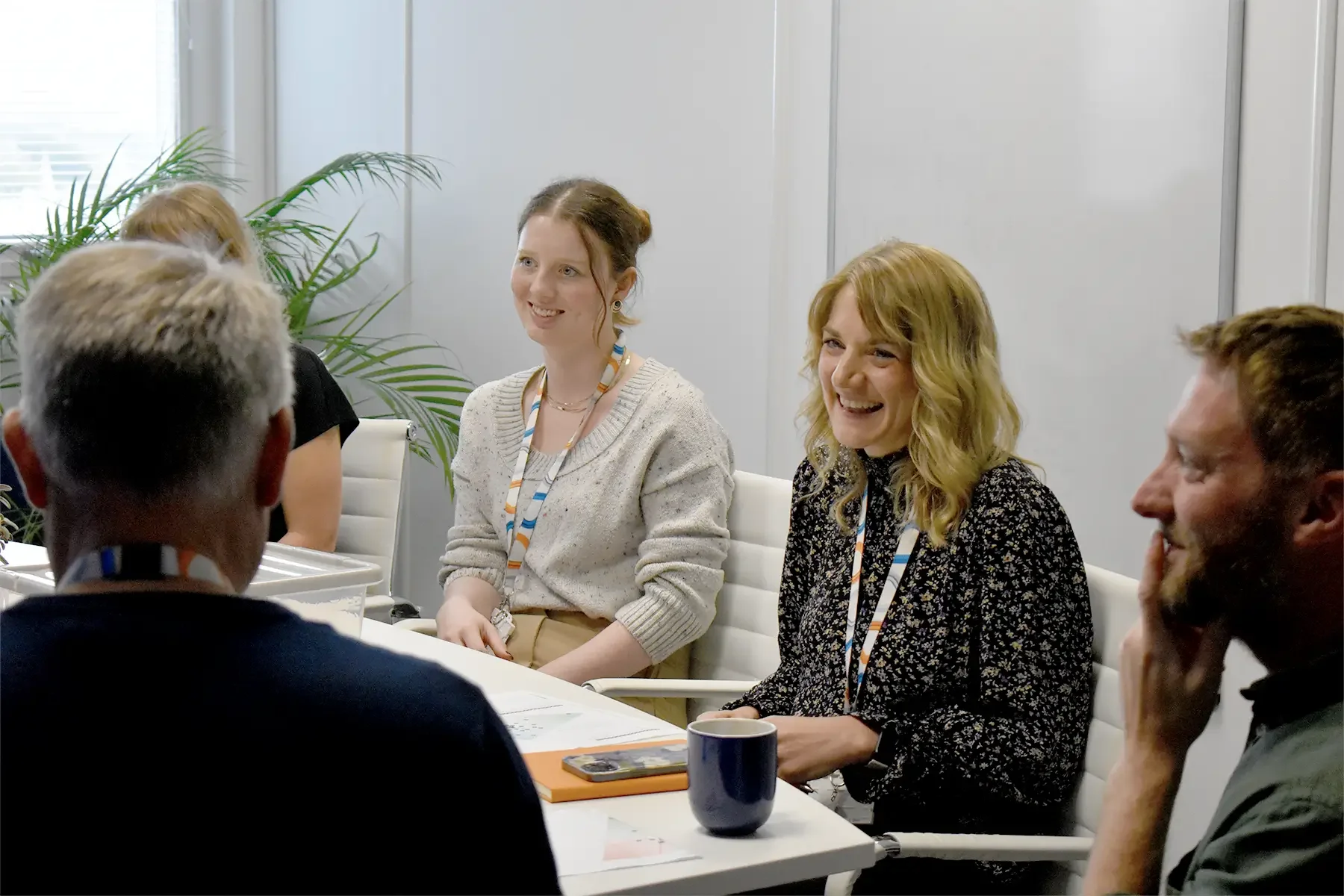 Clarion team members talking and smiling in a team meeting
