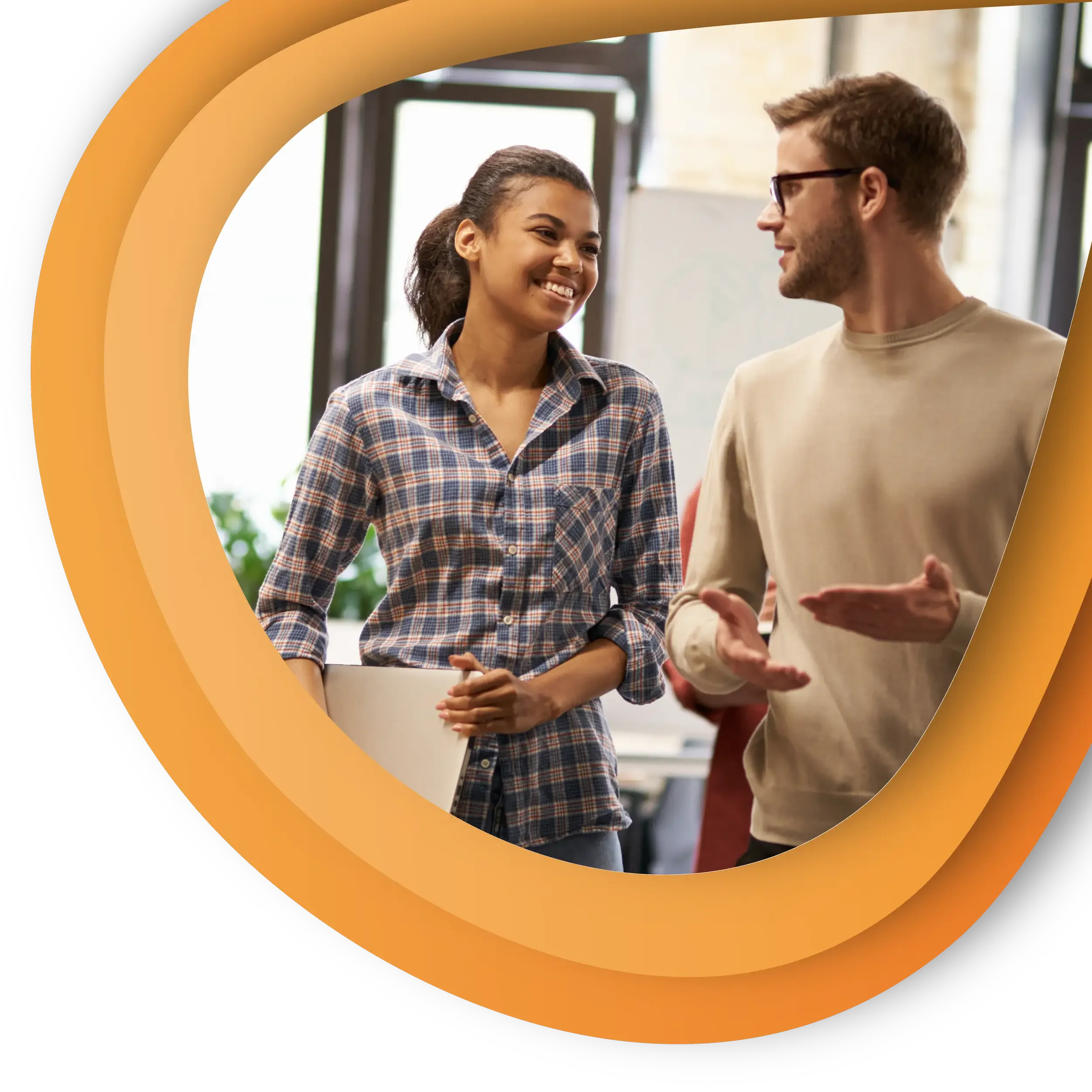 Man and woman smile and chat in an office