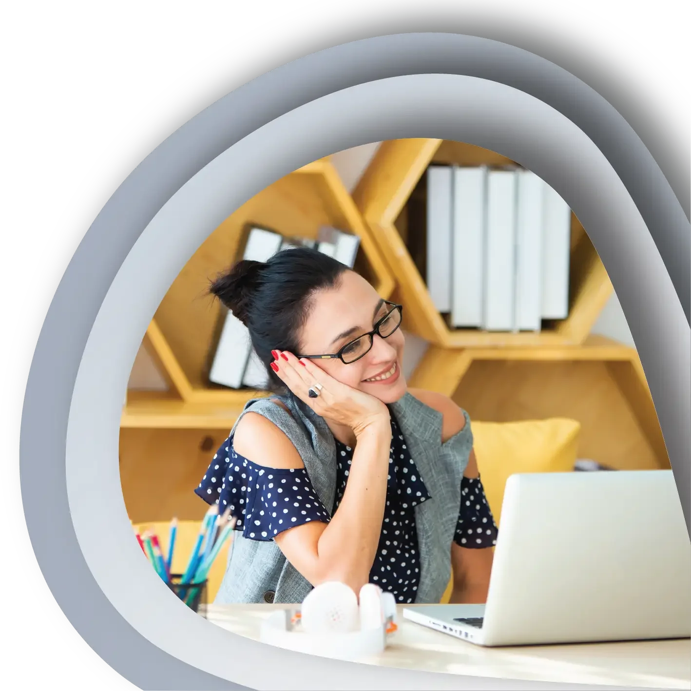 Woman smiles at a computer screen